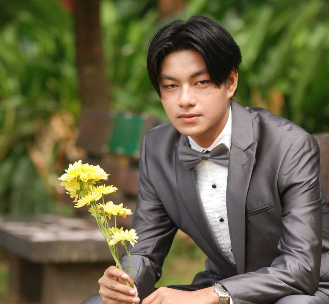 A man posing with flowers A man posing with flowers