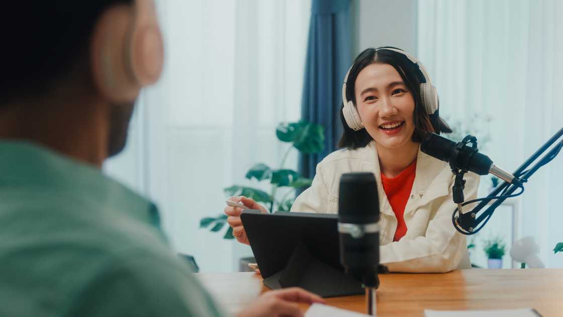 A lady on a podcast session A lady on a podcast session