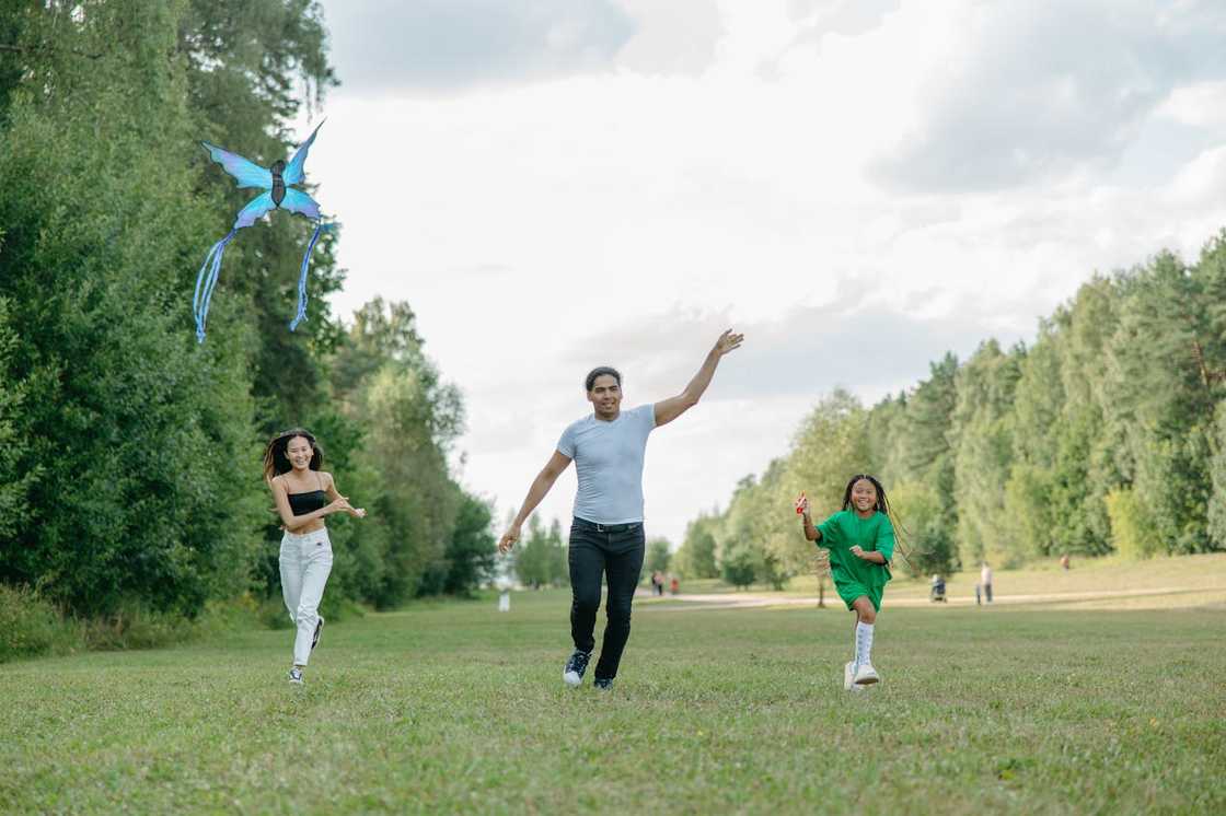 A family playing together outdoors. A family playing together outdoors.