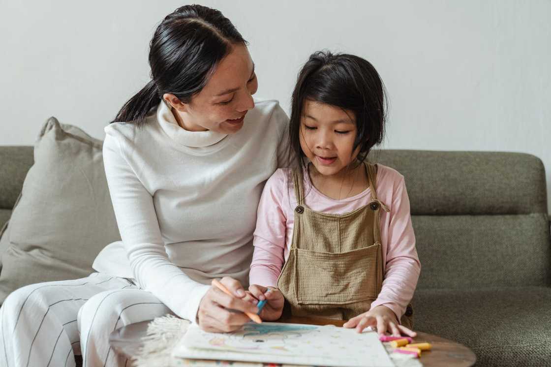 A mother helping her daughter study. A mother helping her daughter study.