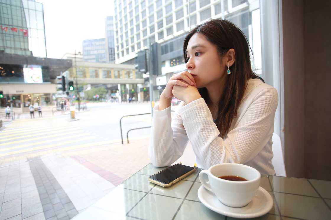 A sad lady at a cafe A sad lady at a cafe