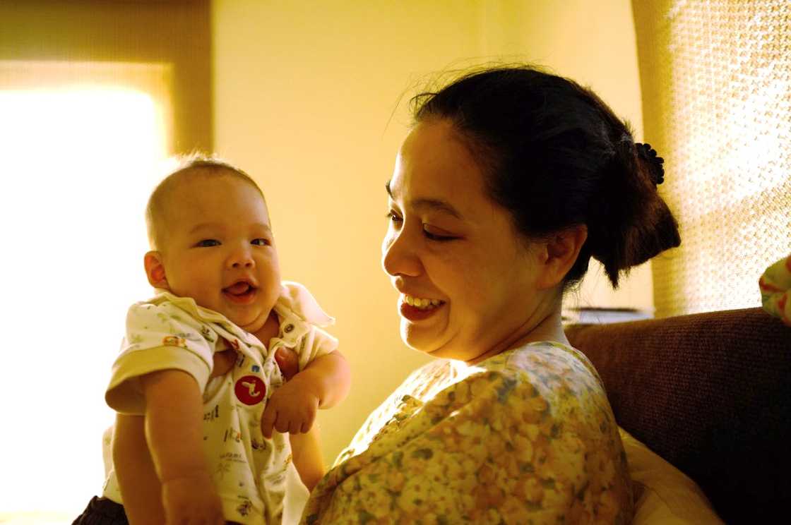 A mother holds her newborn baby. A mother holds her newborn baby.