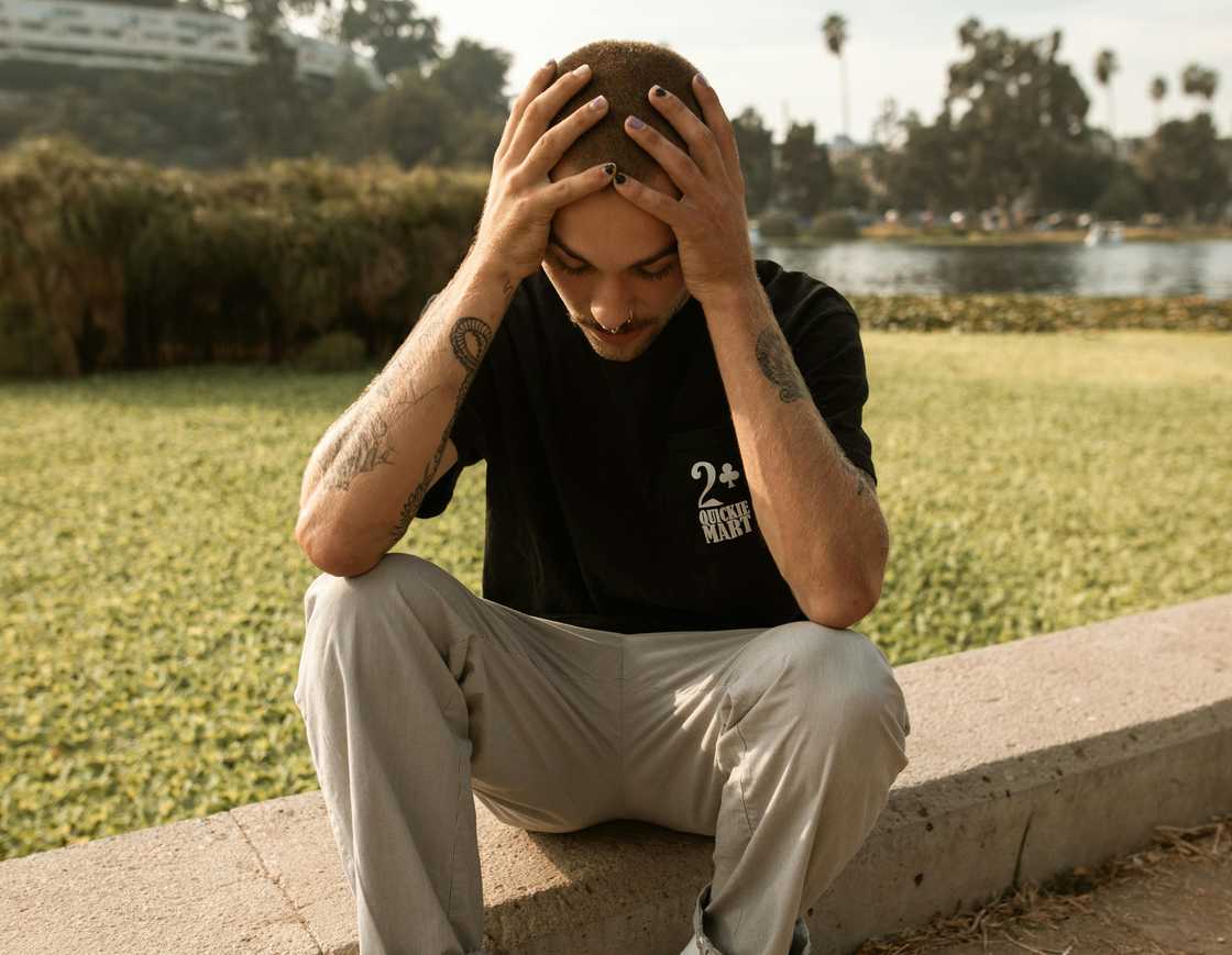 A stressed man holding his head A stressed man holding his head
