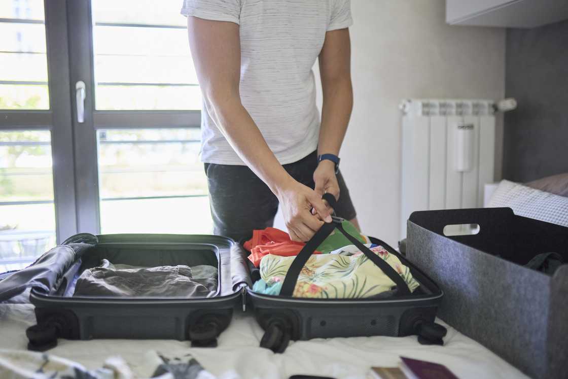 Man packs his belongings Man packs his belongings