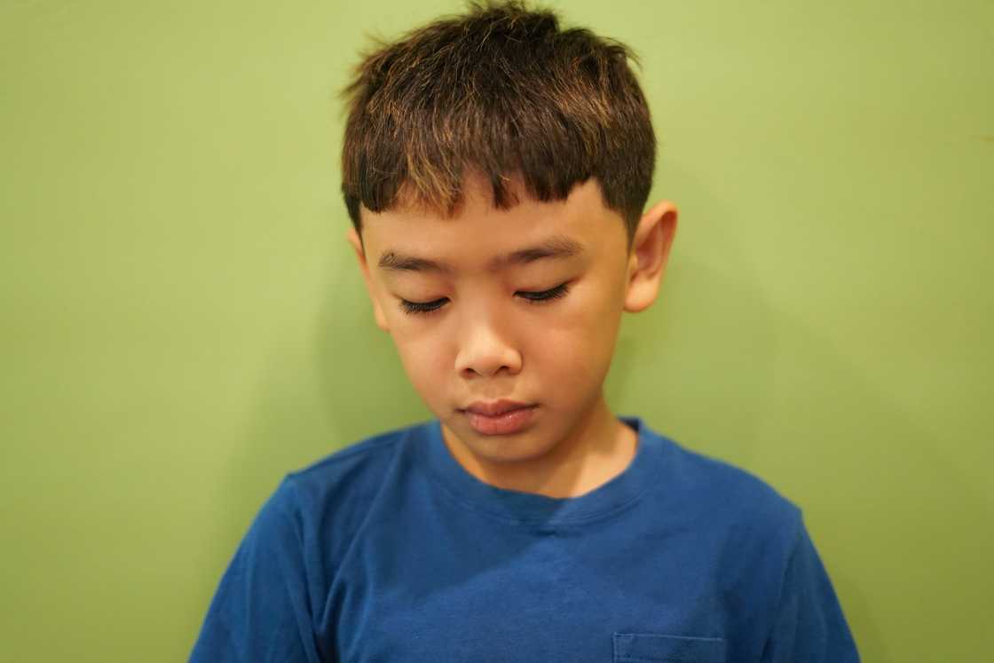 A sad boy looking down