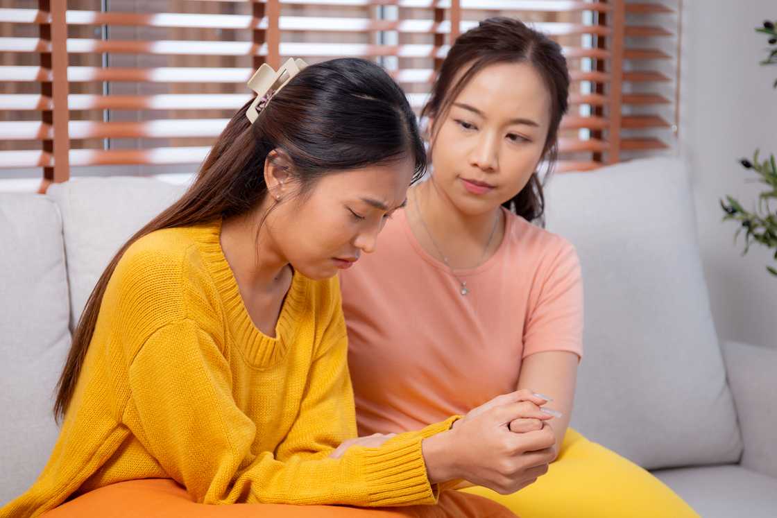 Young woman comforting a friend Young woman comforting a friend