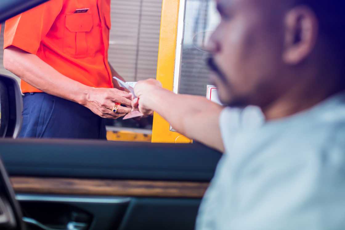 A man paying a taxi driver A man paying a taxi driver