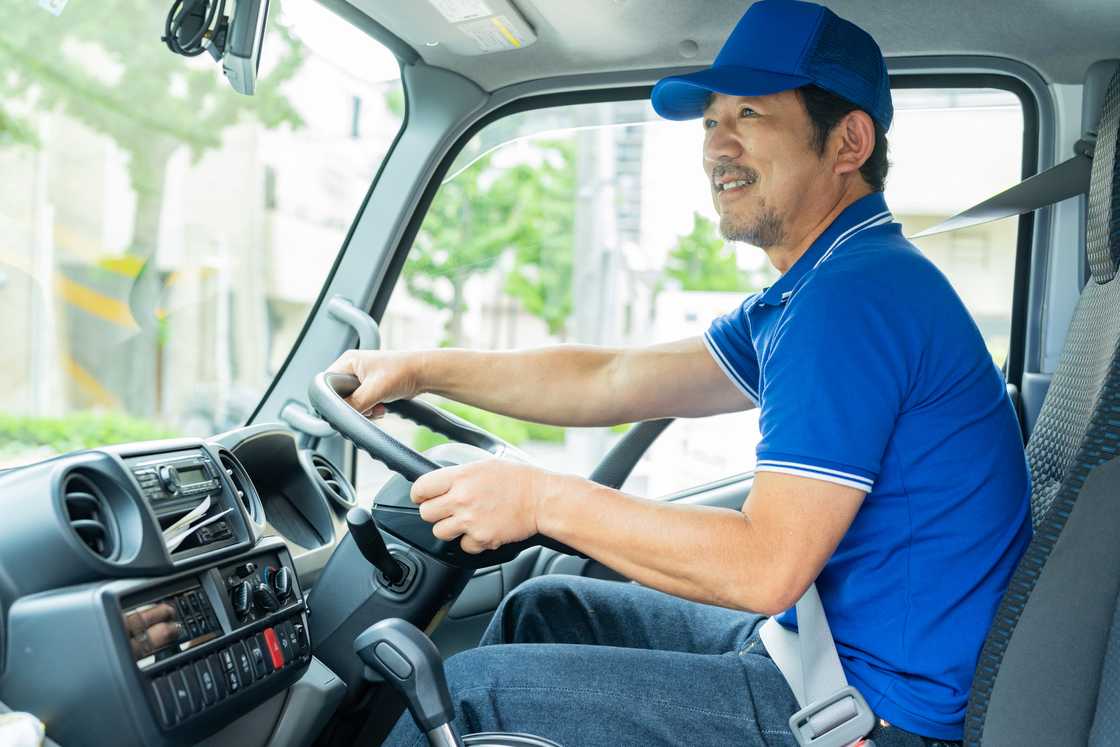 A man is driving a truck A man is driving a truck