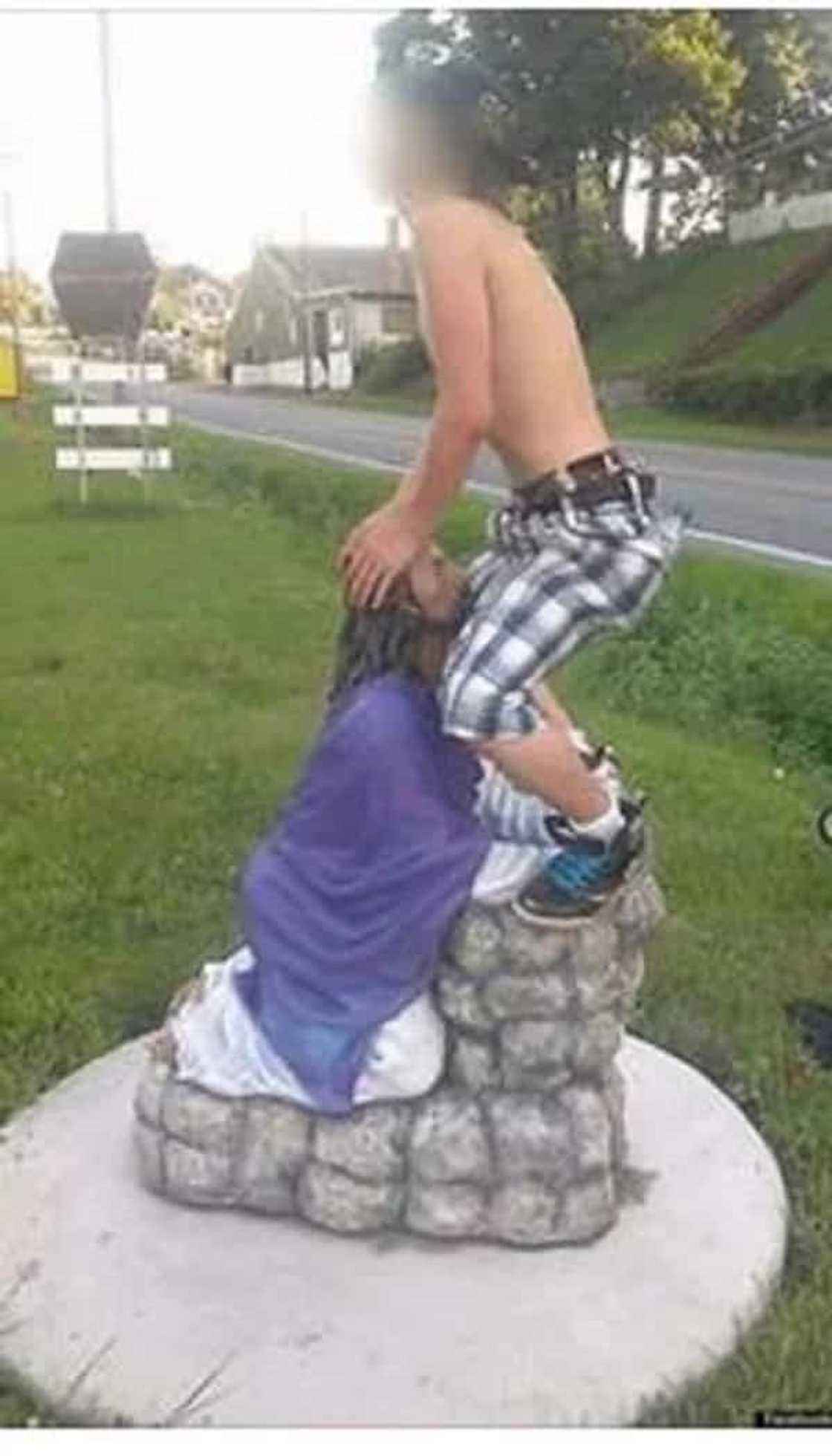 Man disrespects Jesus Christ by posing with a statue like this Man disrespects Jesus Christ by posing with a statue like this