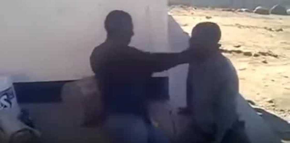 Two thieves are made to beat each other as punishment Two thieves are made to beat each other as punishment