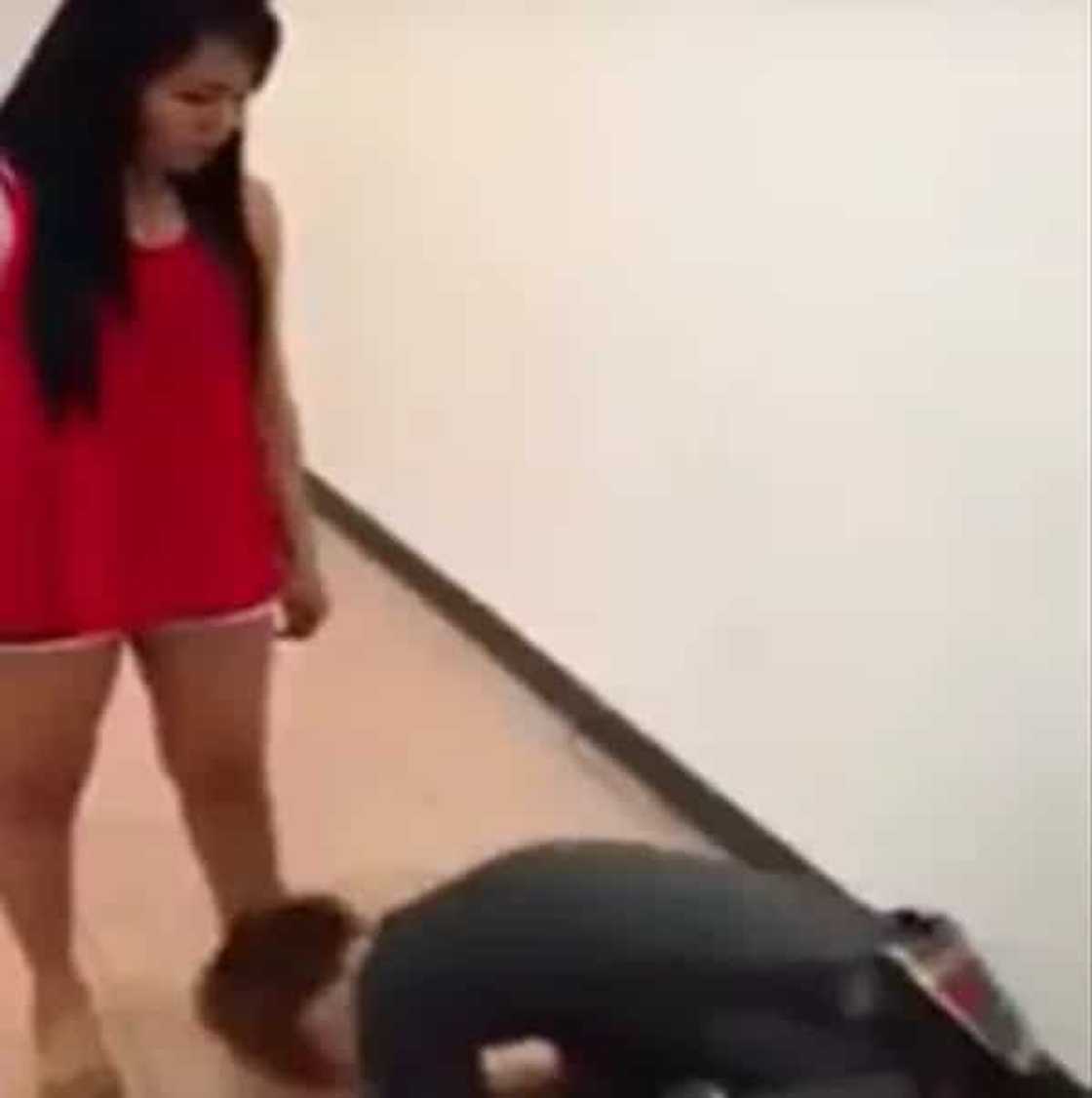 Furious girl violently kicks and punches her miserable boyfriend. He begs her to stop. Furious girl violently kicks and punches her miserable boyfriend. He begs her to stop.