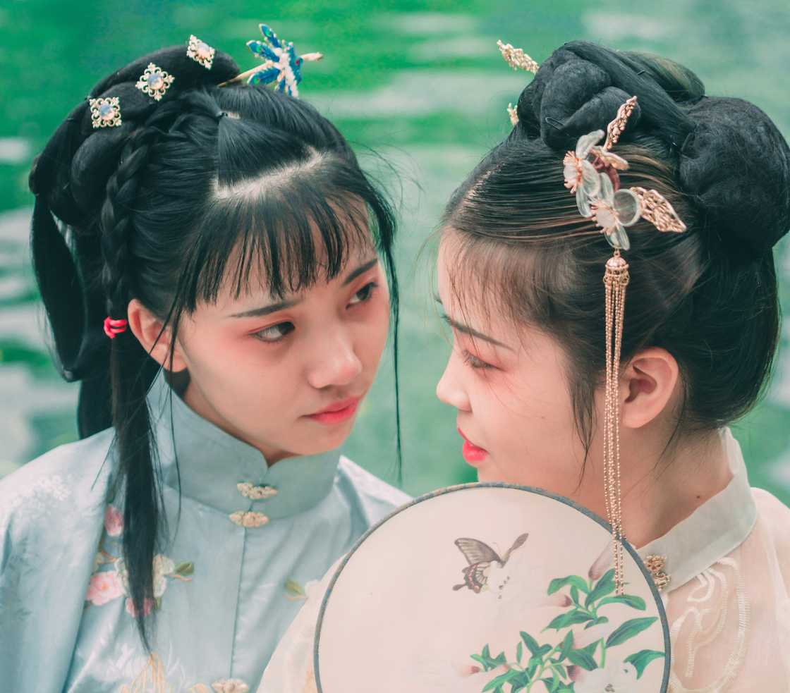 Two sisters looking at each other with love Two sisters looking at each other with love