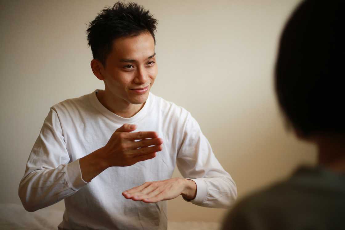 A father and daughter using sign language
