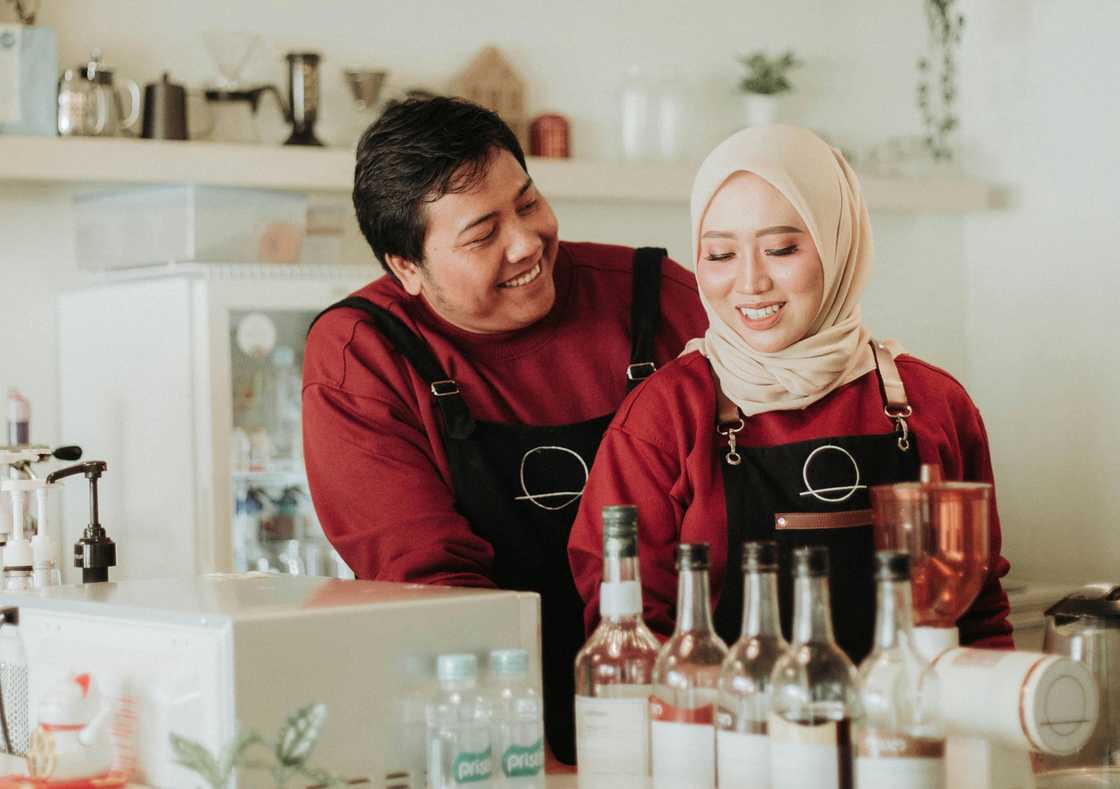 A couple filming a kitchen challenge.
