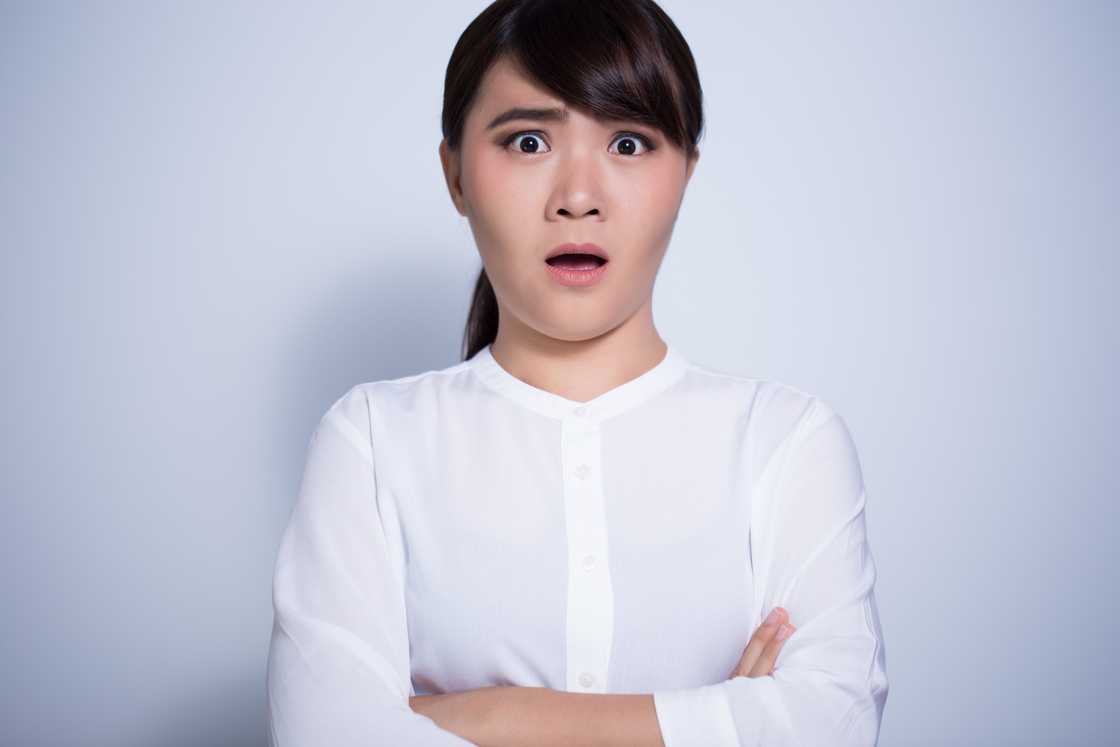 A surprise and unhappy woman folding her arms