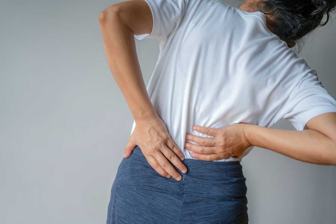 A lady with back pain A lady with back pain