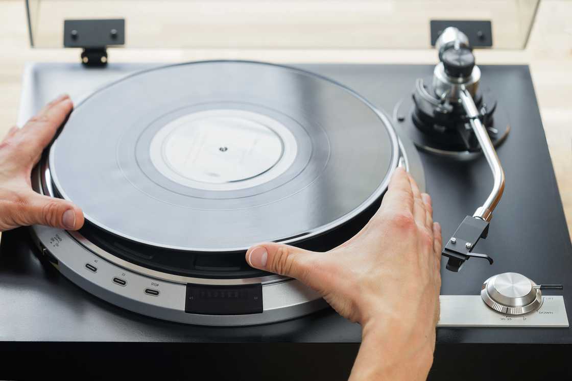 A man placing a record on a turn table
