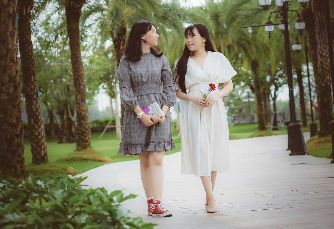 Two sisters walking together as they converse
