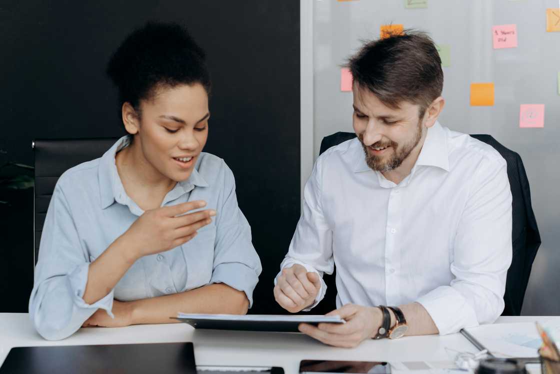 A man and woman talking in an office