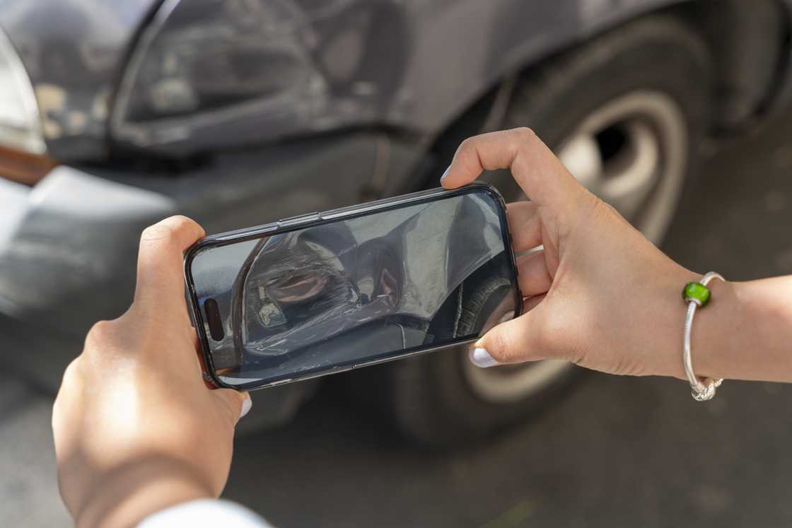 A lady films an accident scene