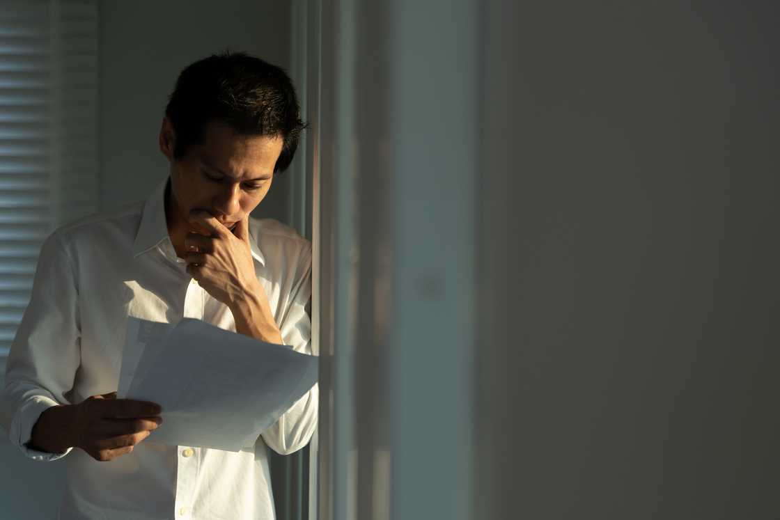 A worried man reading a document