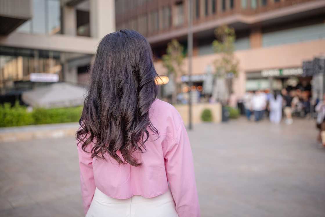 A woman walking outdoors in the city A woman walking outdoors in the city