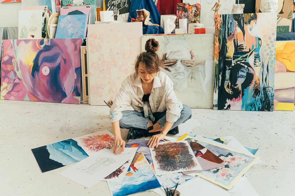 An artist reviews her collection of paintings.