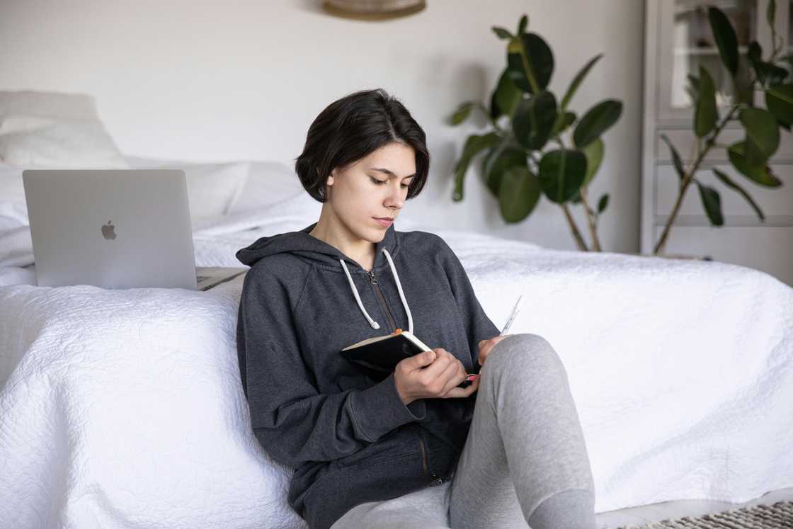 A young woman reading a journal