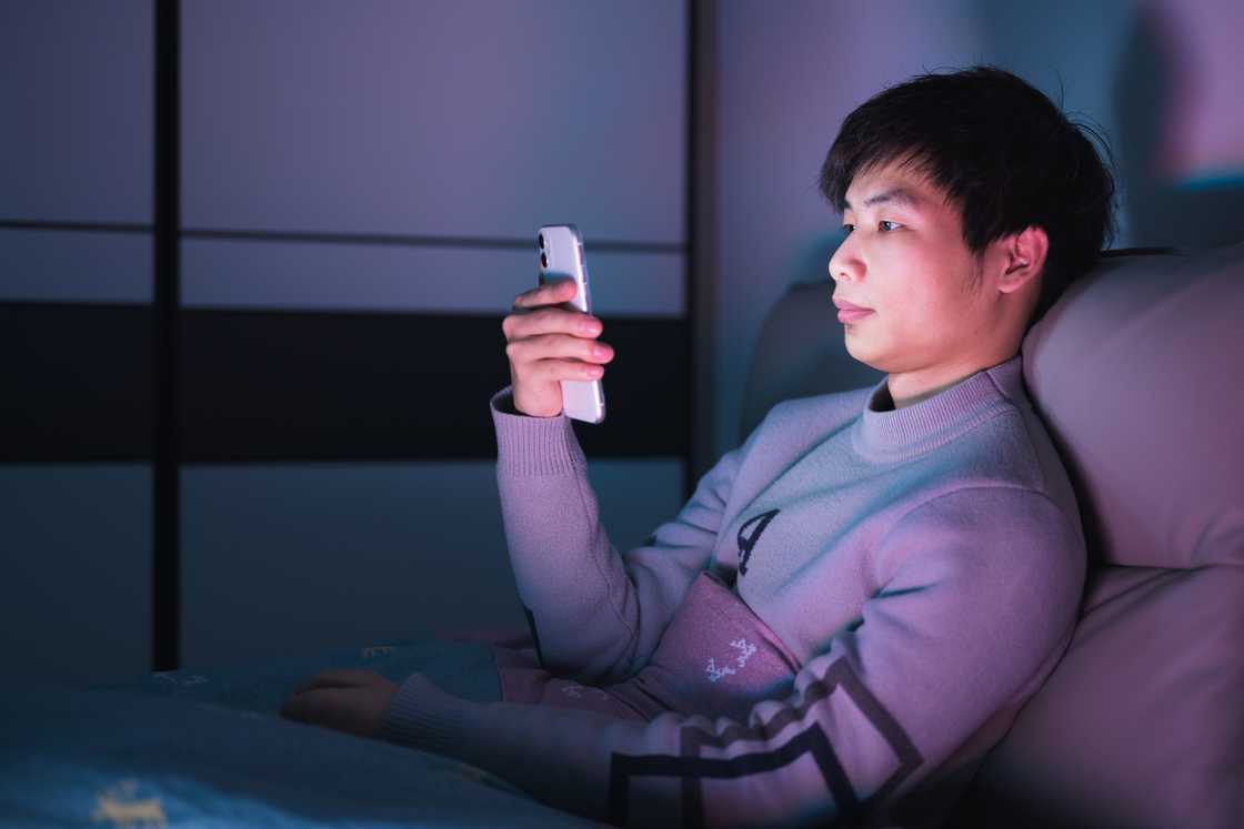 A man is reading a text on his phone