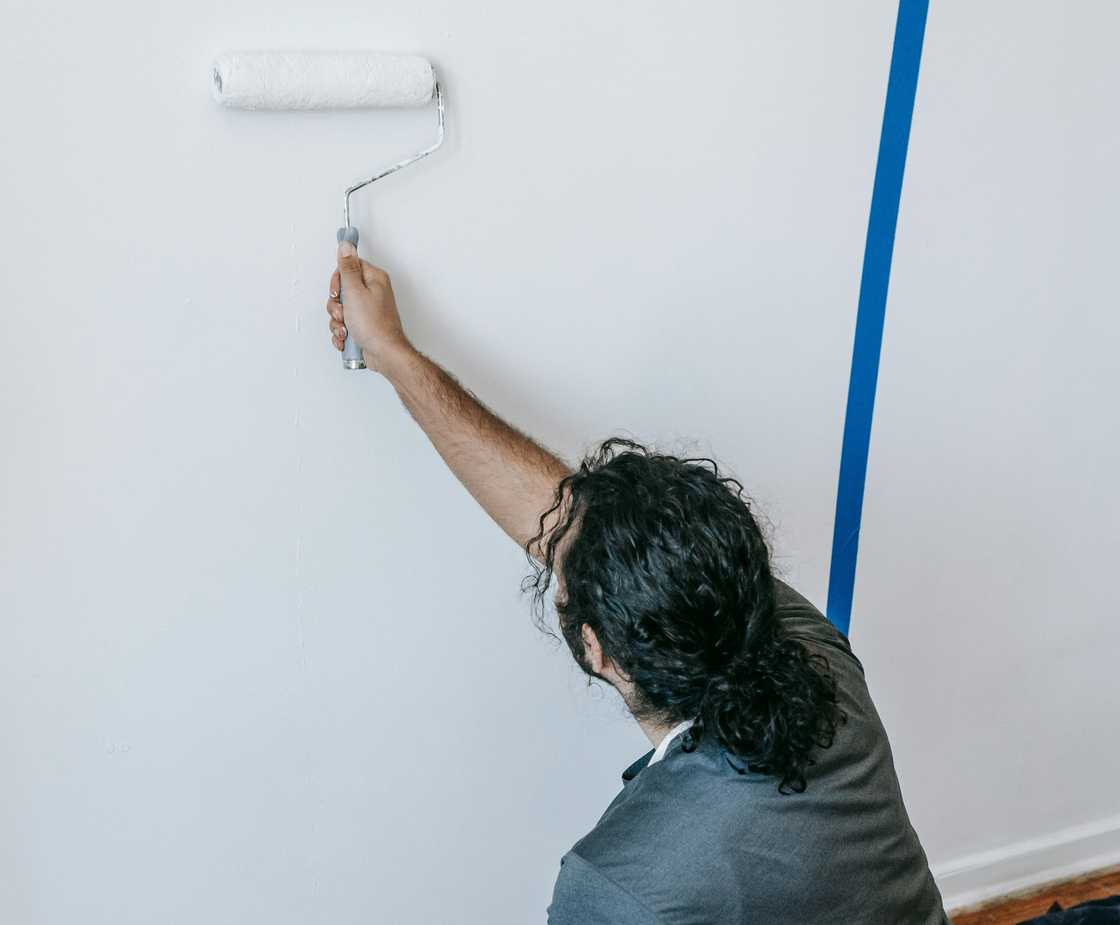 A man painting his house