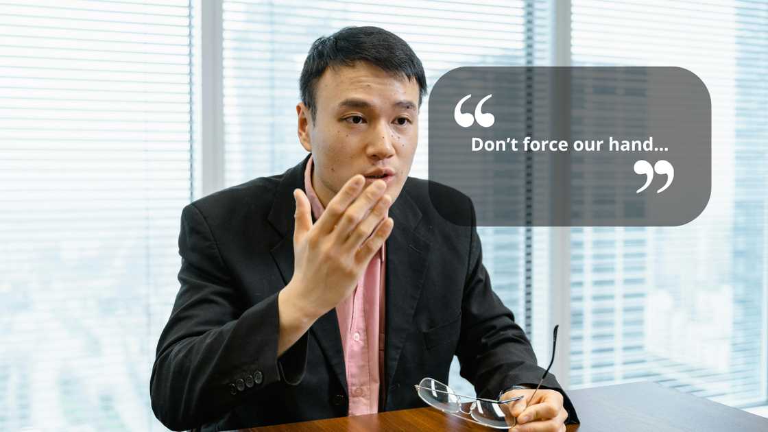 A seious councillor talking to someone in the office