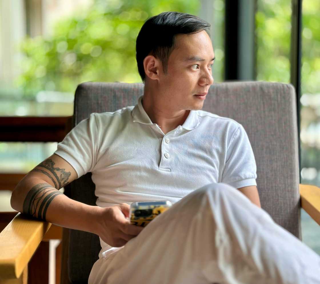 A houghtful young man looking through window