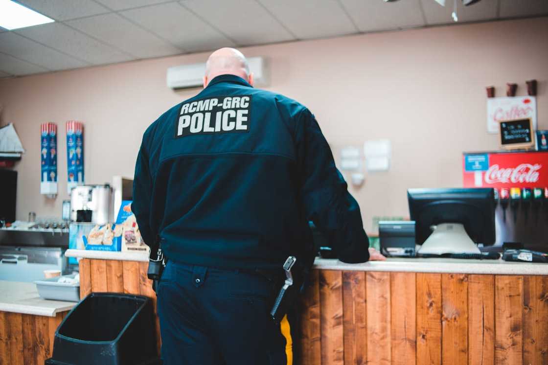 A police officer stands in the canteen of a police station.