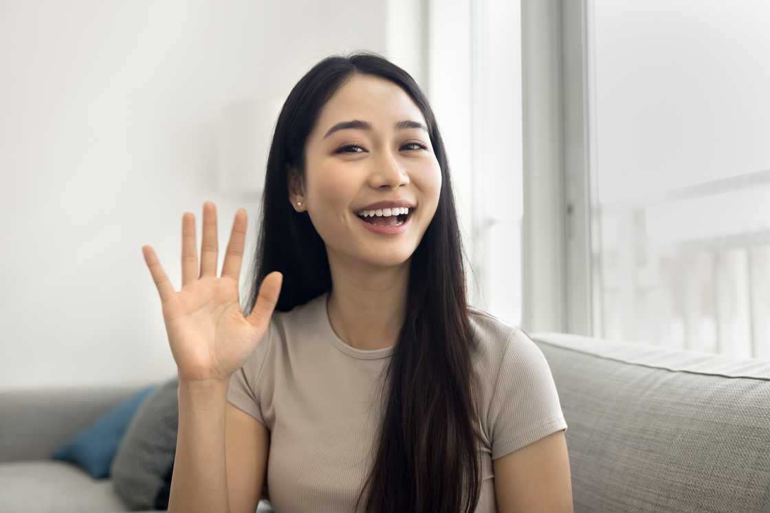 A young woman waving A young woman waving