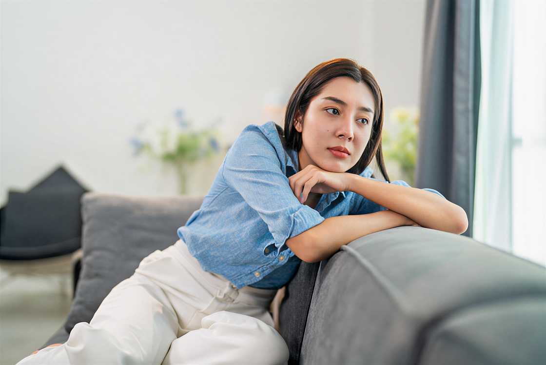 A young woman is looking away at the window A young woman is looking away at the window