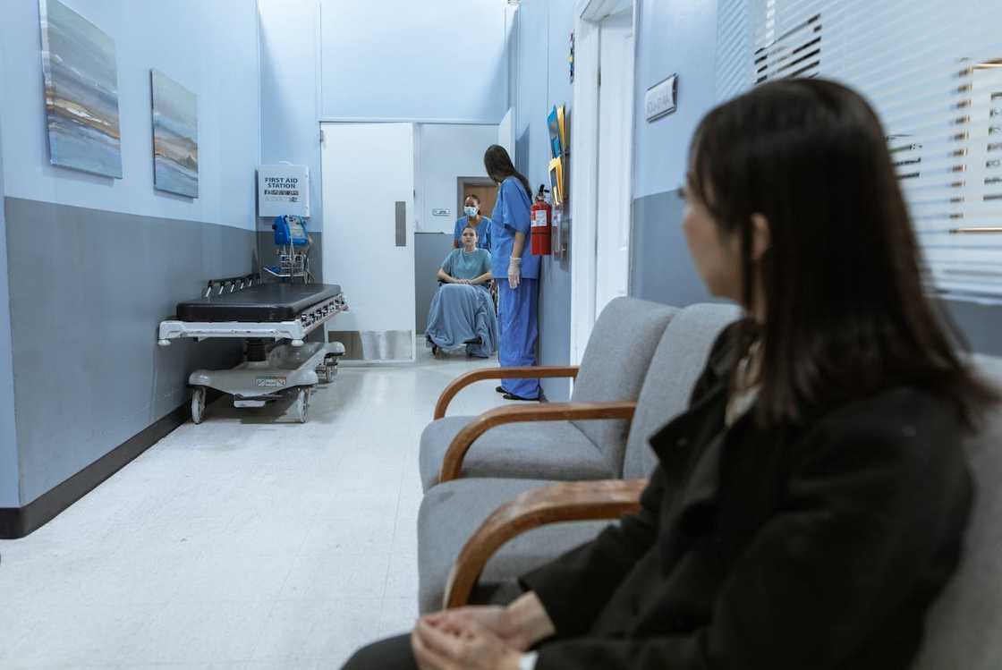A woman sits apart at the hospital waiting area. A woman sits apart at the hospital waiting area.