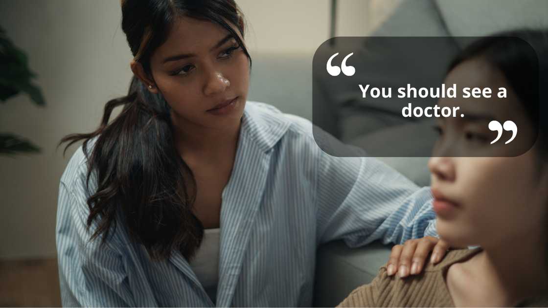 Two friends talking one advising the other while sitting on the couch Two friends talking one advising the other while sitting on the couch