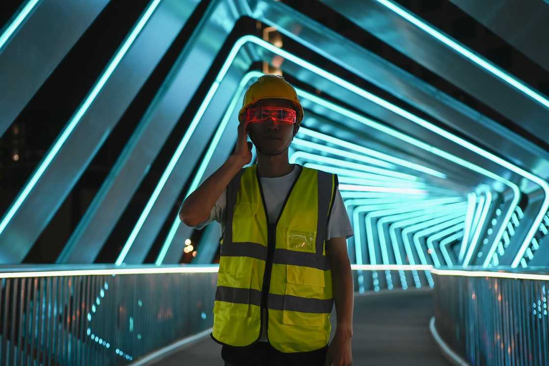 A man in a reflective vest at night during patrol A man in a reflective vest at night during patrol