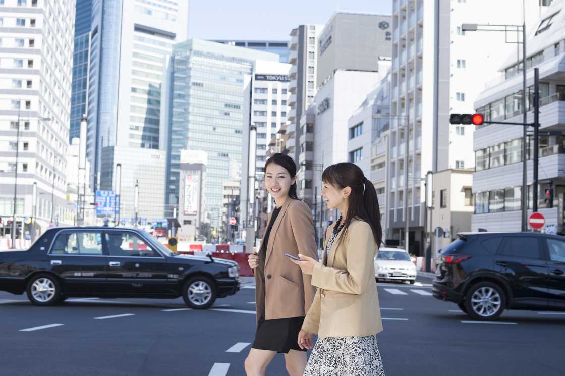 Two ladies crossing the street