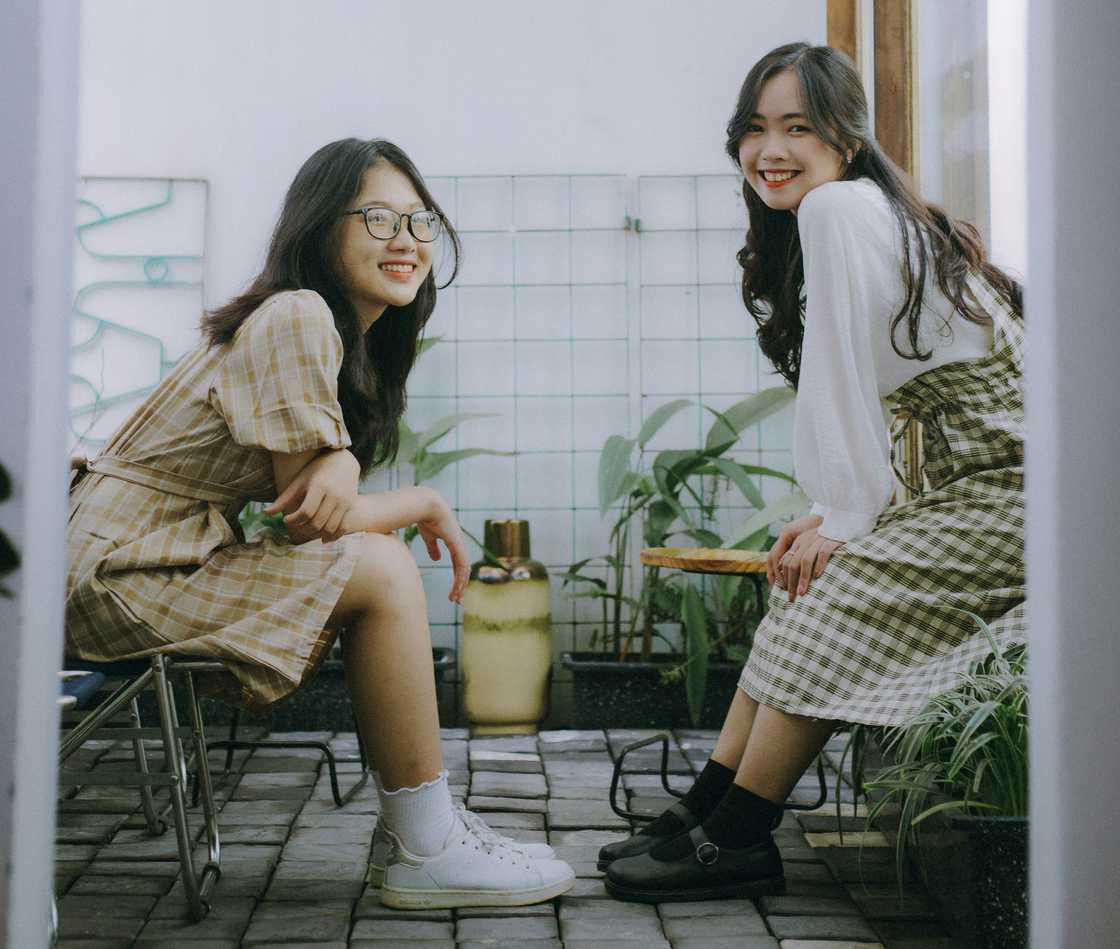 Two siblings talking indoors