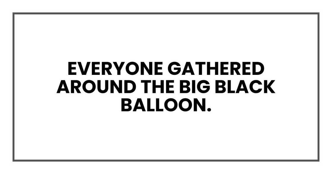 Everyone gathered around the big black balloon.