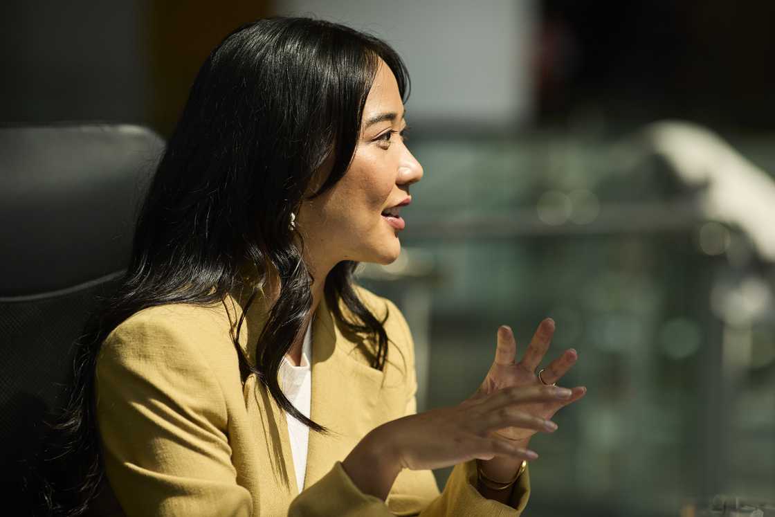 A woman is talking while in the office A woman is talking while in the office
