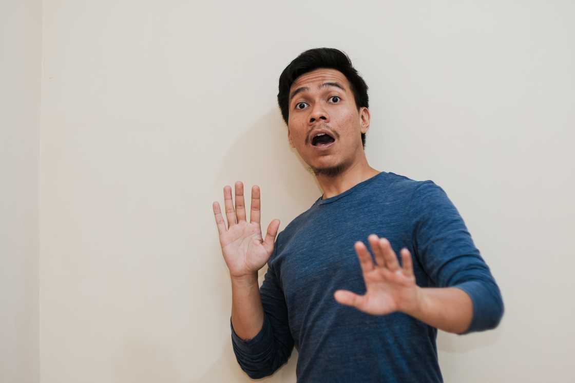 A terrified man entering a house