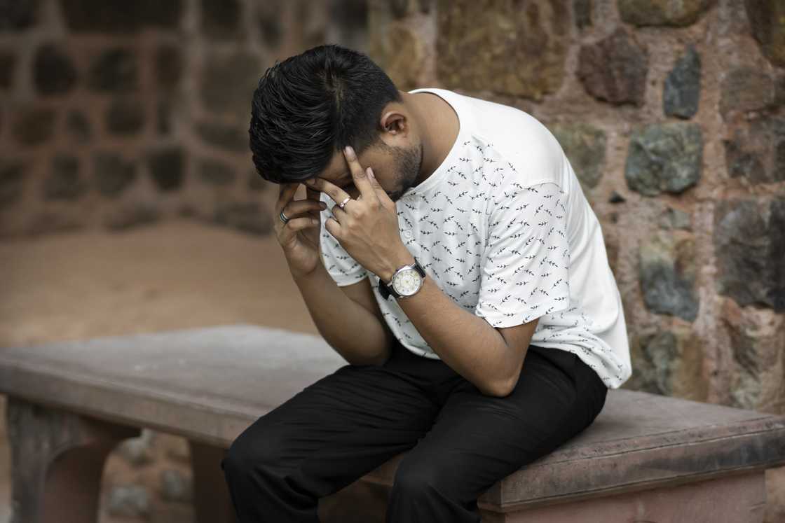 A guilty man holding his head A guilty man holding his head