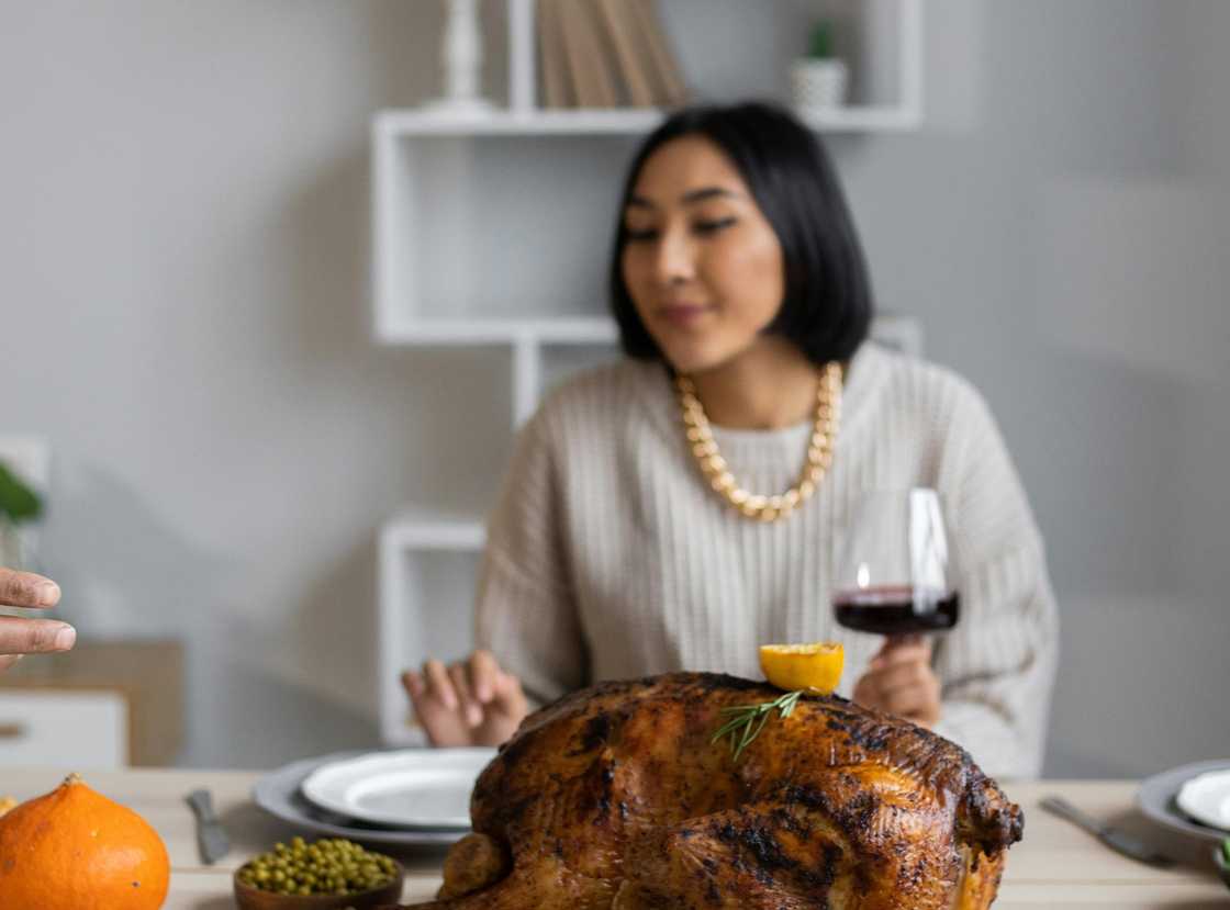 A woman with a troubled expression at a family dinner.