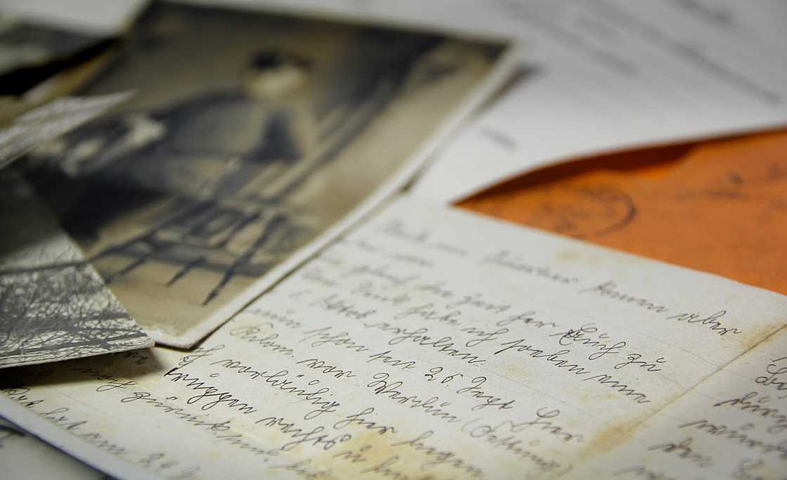 A close-up of handwritten letters spread across a table. A close-up of handwritten letters spread across a table.