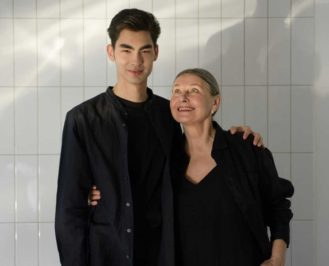 A woman posing with her son A woman posing with her son