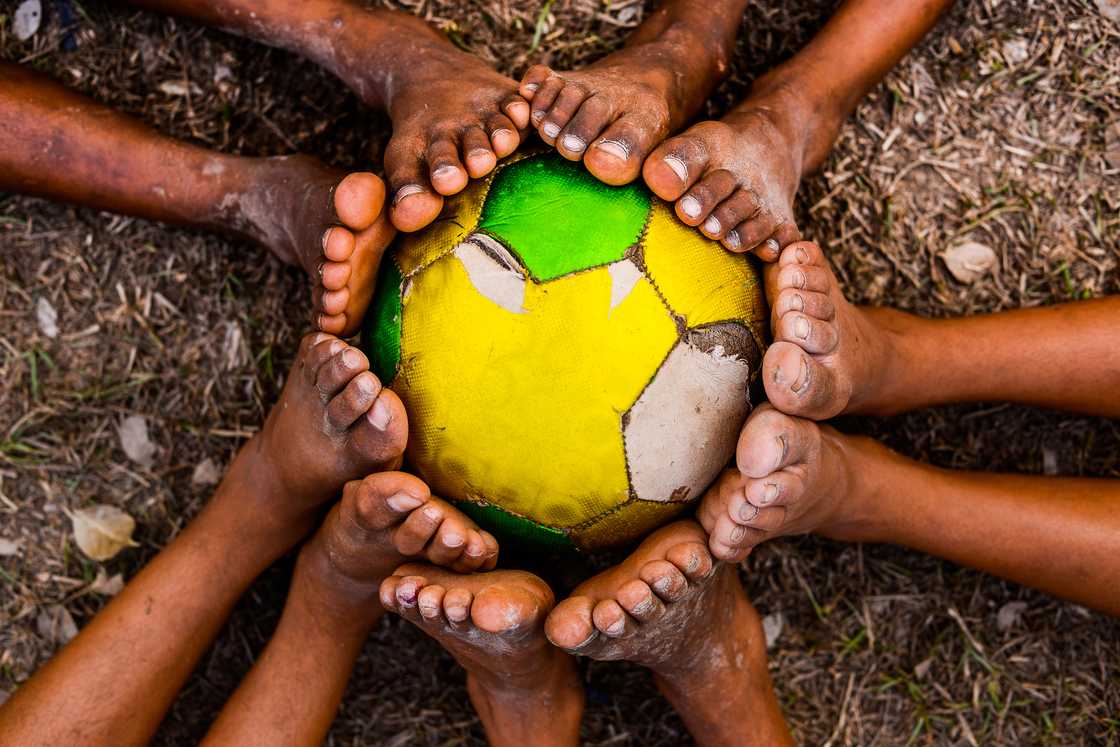 Kids with a worn out football