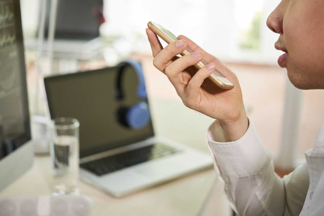 A man uses phone on loud speaker