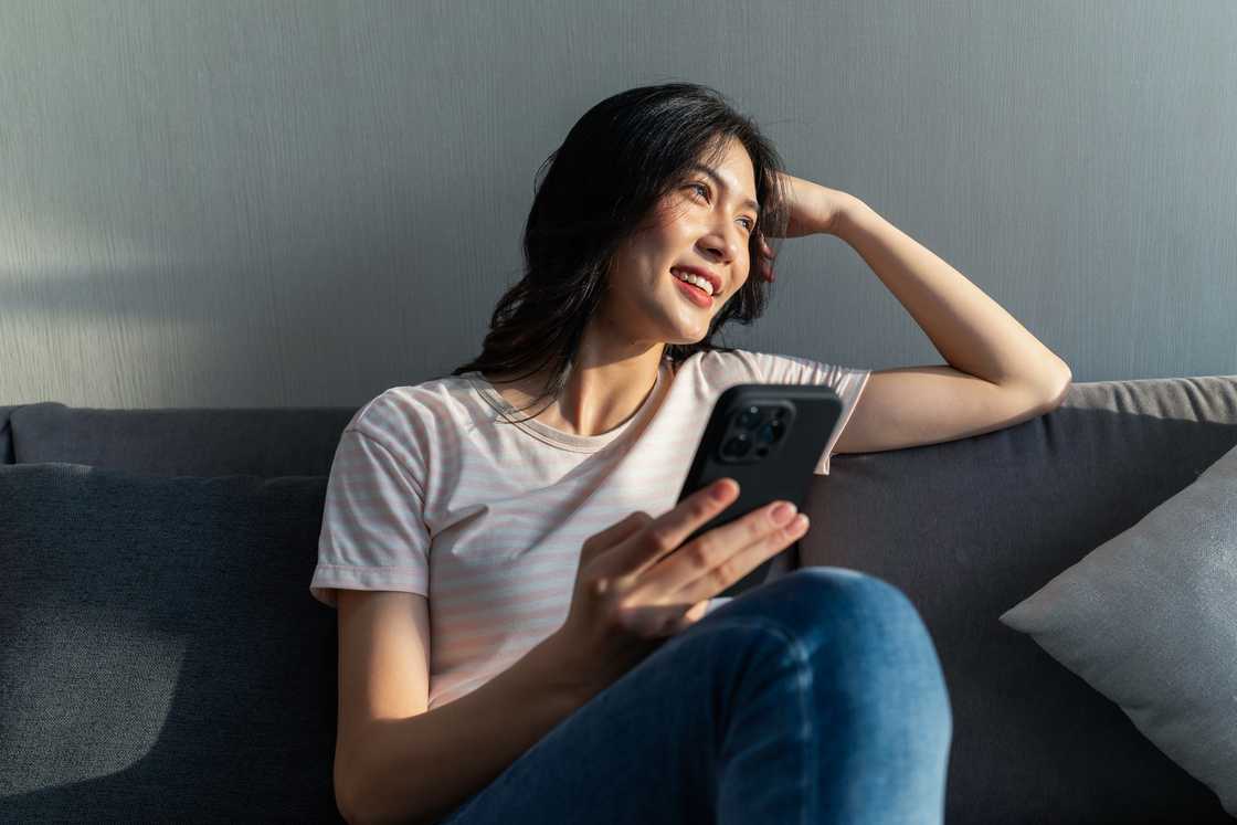 A lady holding a phone A lady holding a phone
